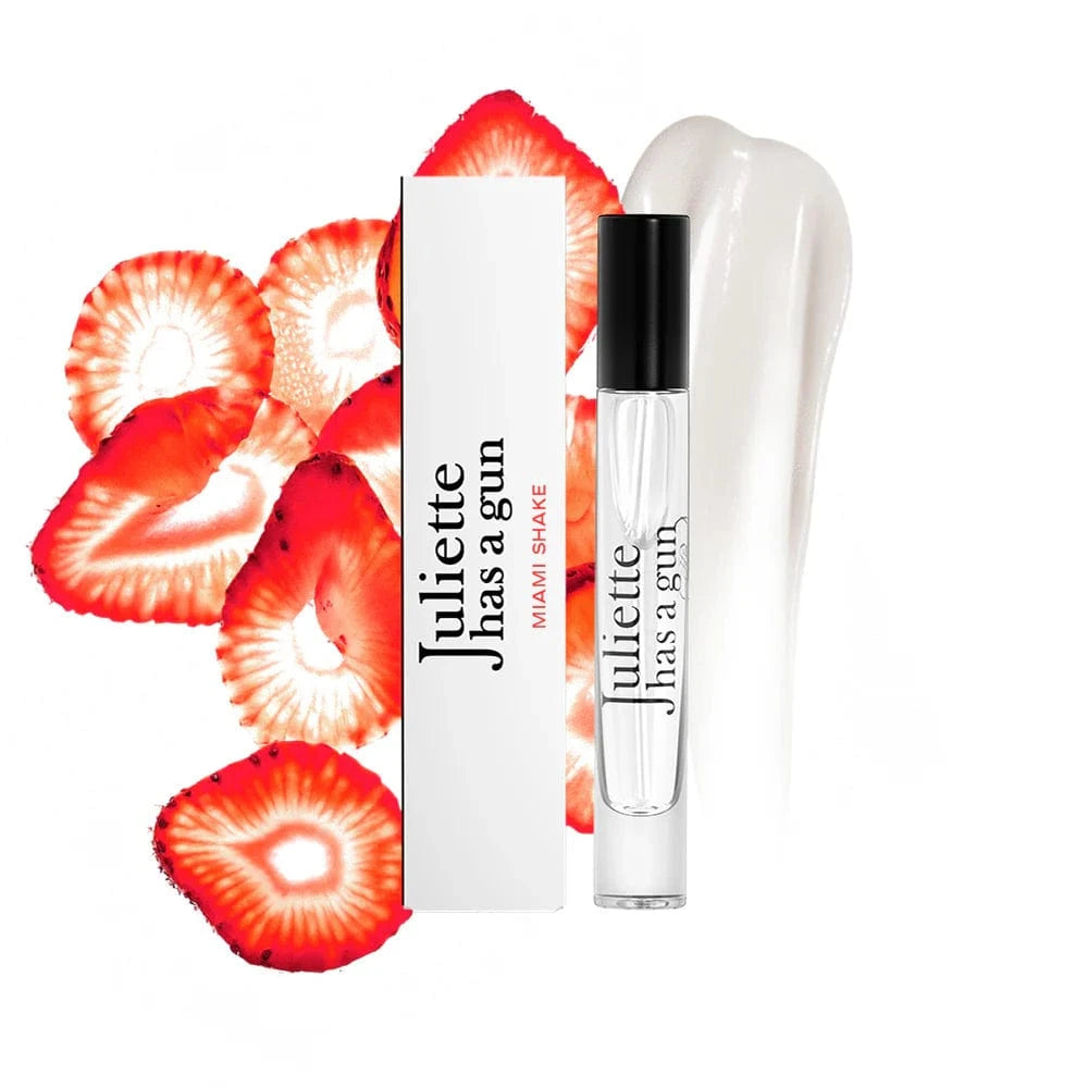 Perfume bottle and packaging with strawberry slices on a white background