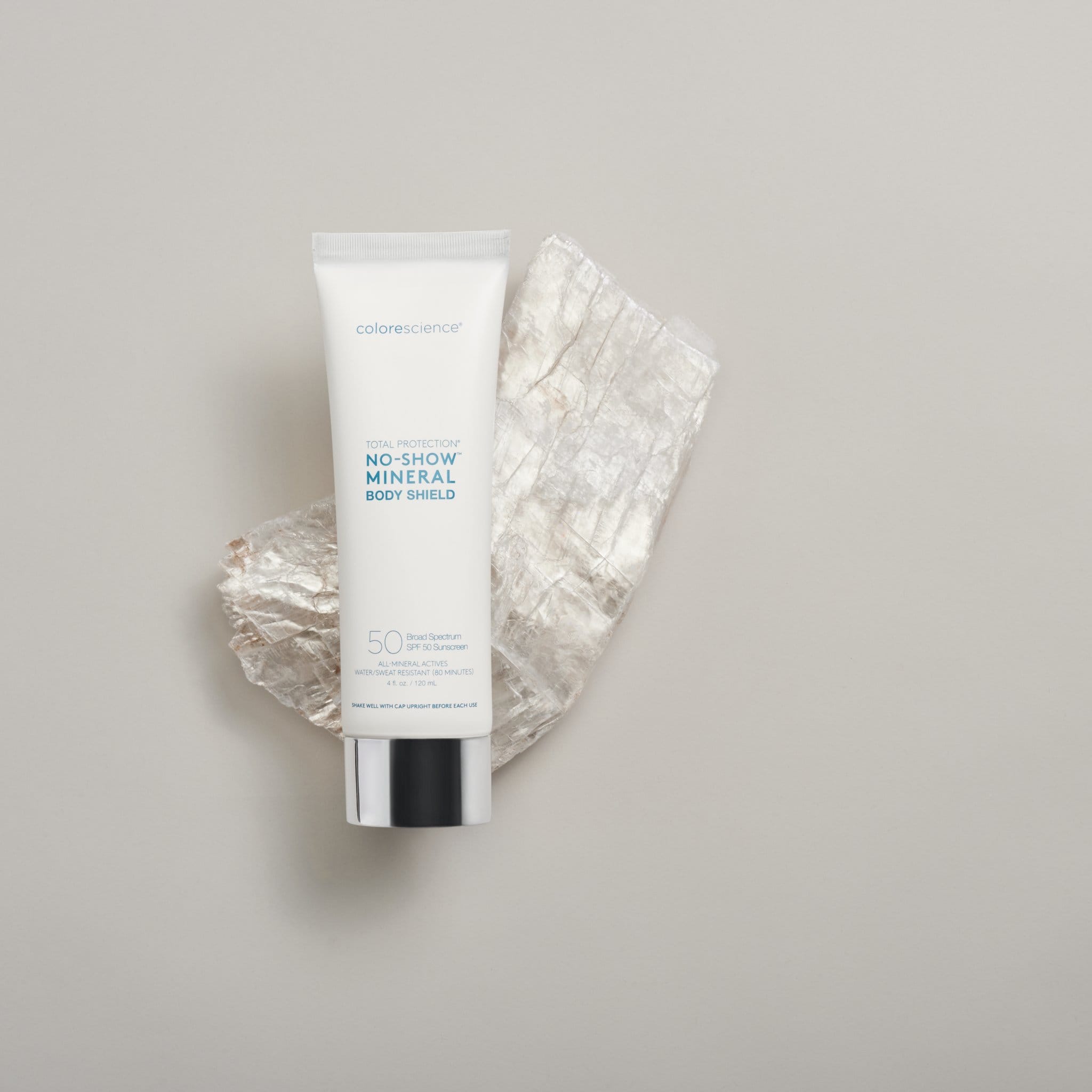 Colorescience No-Show Mineral Body Shield SPF 50 sunscreen hero shot resting on crystal