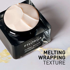 Filorga Global-Repair Advanced Cream melting wrapping texture open jar with gold streak on marble