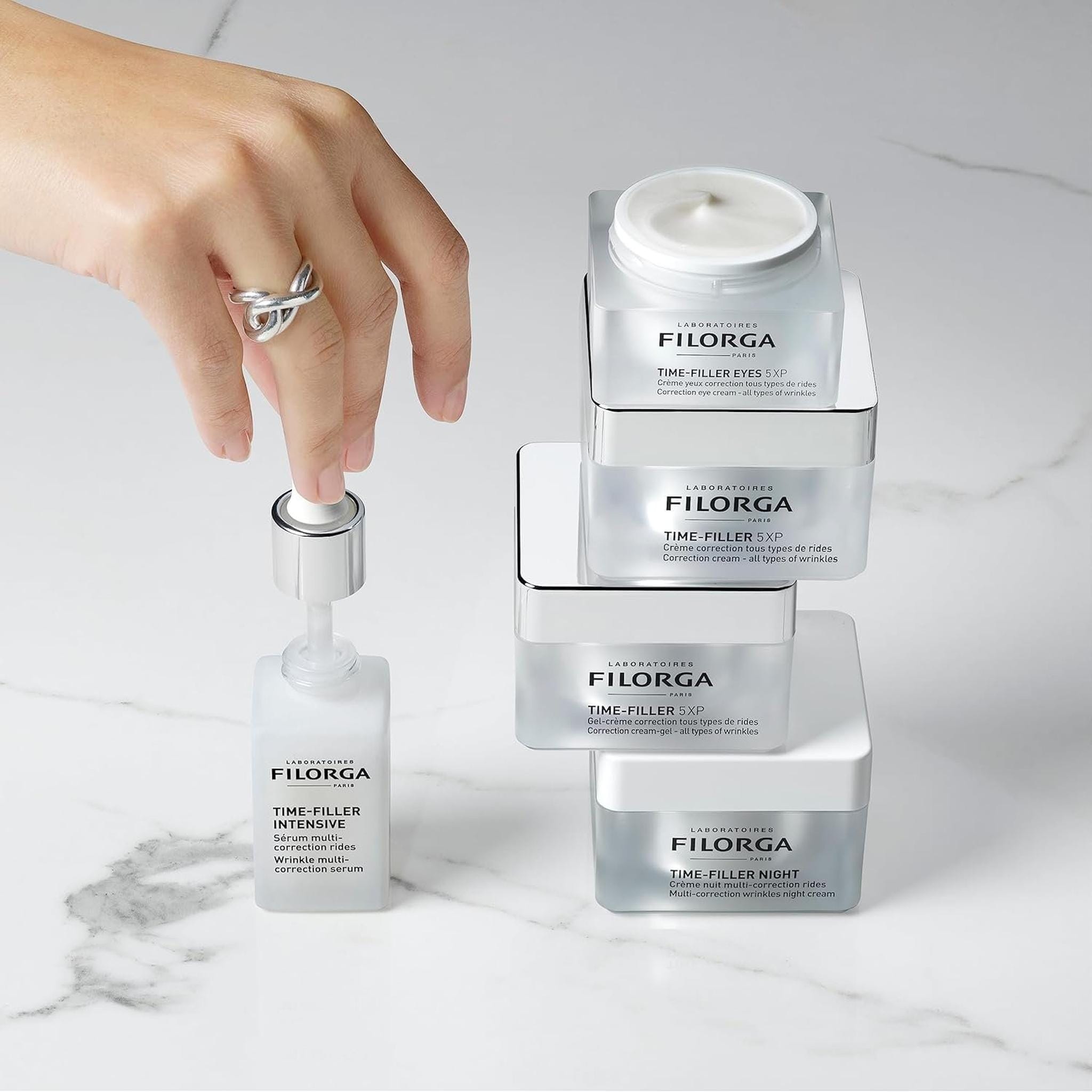 Filorga Time-Filler collection 5XP cream gel night cream Eyes 5XP and Intensive serum stacked on marble