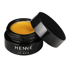 Henné Organics Lip Mask in a black glass jar with lid off showing golden honey-colored overnight lip balm