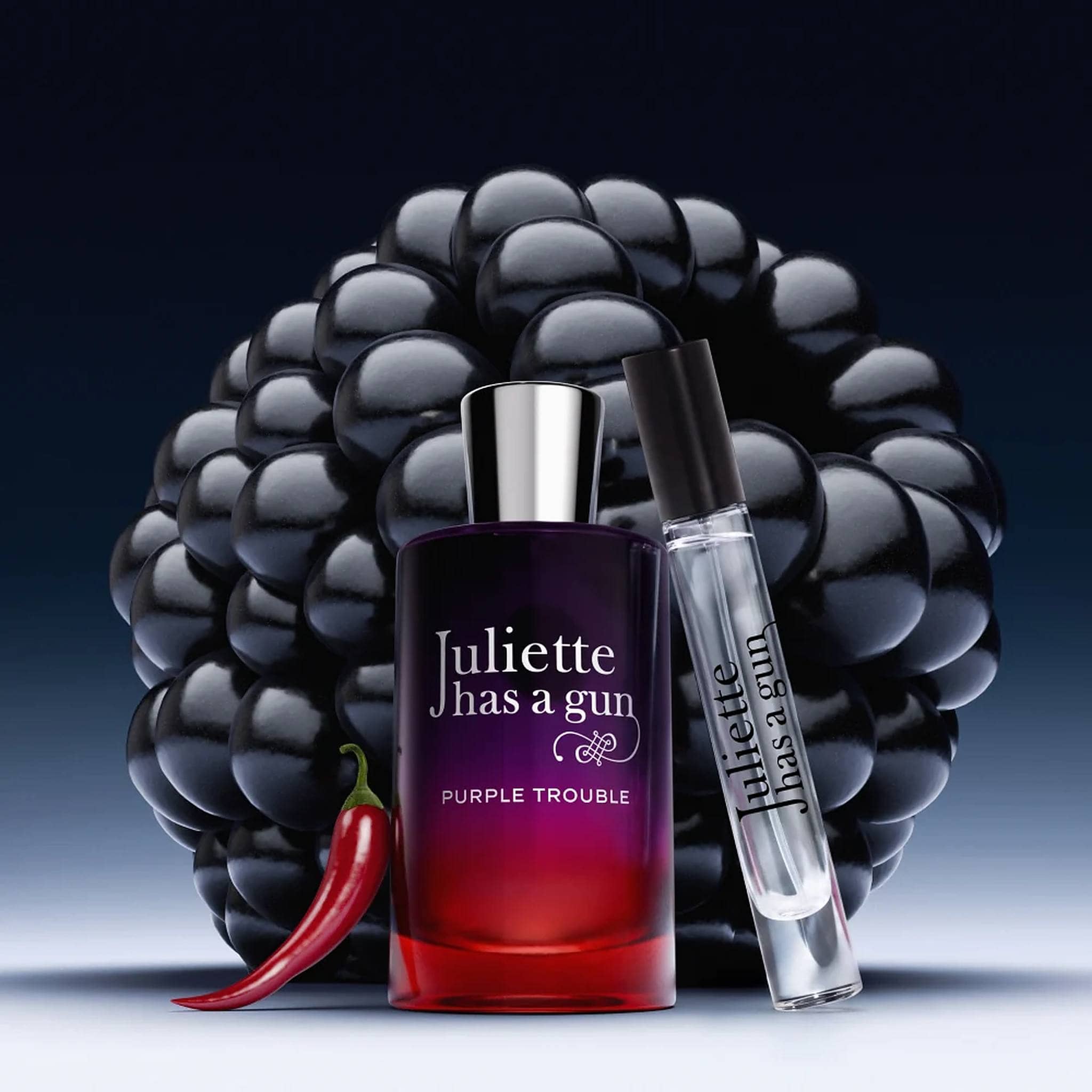 Juliette Has a Gun Purple Trouble travel spray and box with blackberries and red chili pepper