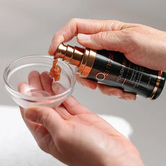 Hand dispensing Osmosis Polish MD Cranberry Enzyme Mask from pump into glass bowl