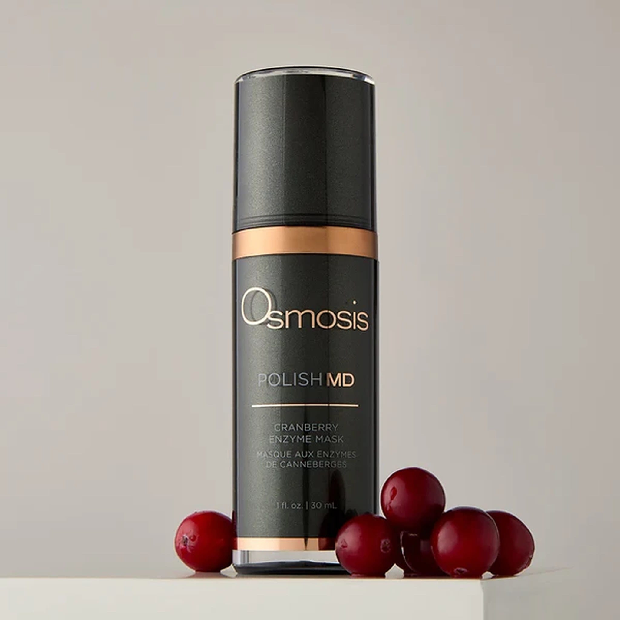 Osmosis Polish MD Cranberry Enzyme Mask bottle beside fresh cranberries