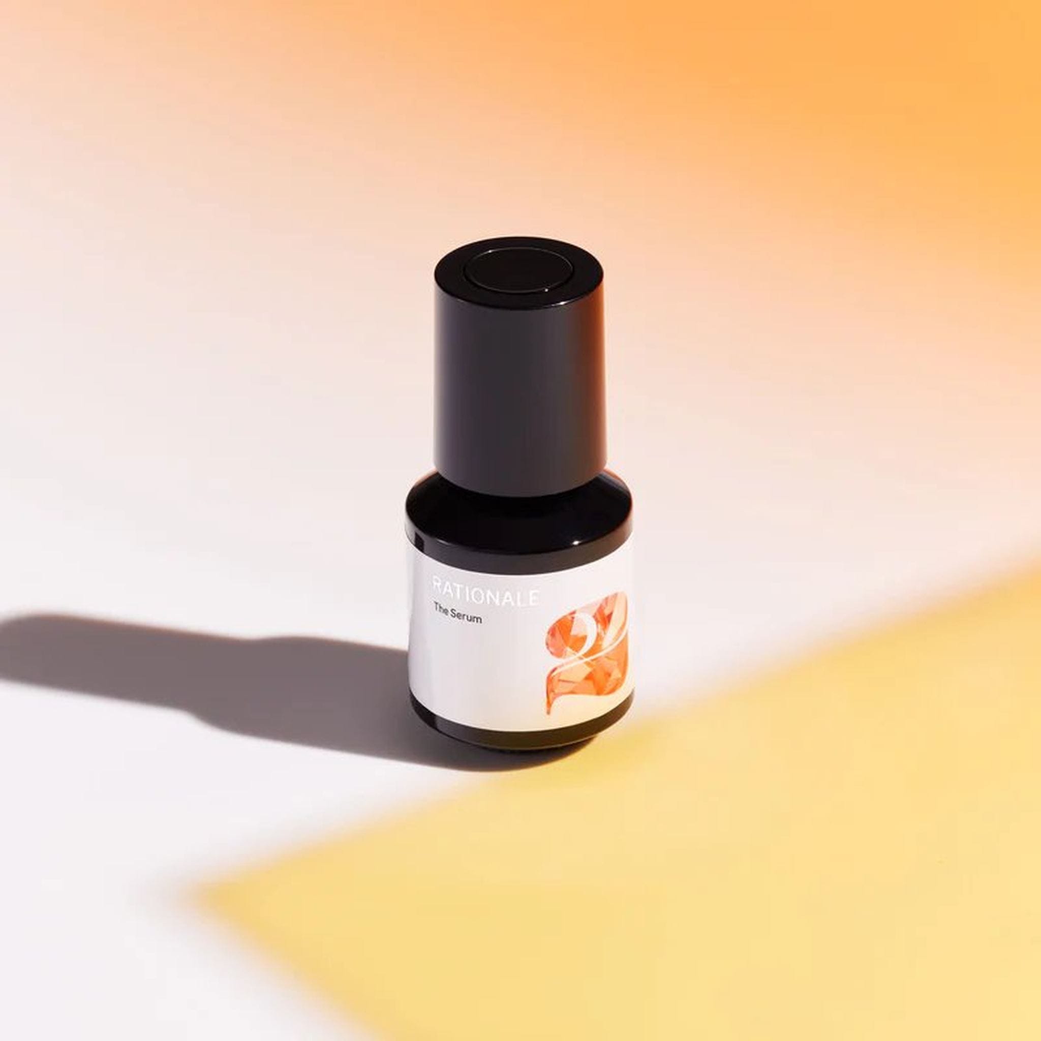 Rationale The Serum number 2 bottle with orange number 2 label styled on warm orange and yellow gradient background