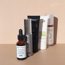Load image into Gallery viewer, Assorted SkinCeuticals skincare products displayed on a beige surface
