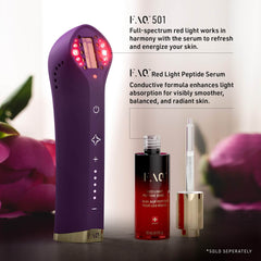 Purple device with red light, serum bottle, and dropper on a blurred floral background