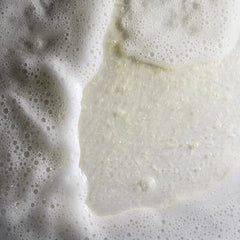Close-up of a textured surface with foam and liquid