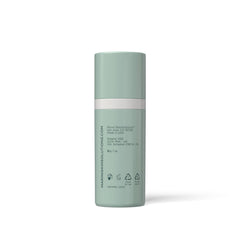 Mint green skincare bottle with white label on a white background