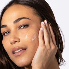 Woman applying ALASTIN HA Immerse Serum to cheek for dewy hydrated skin