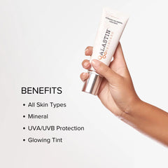 Hand holding ALASTIN HydraTint mineral sunscreen with UVA UVB protection and a glowing tint for all skin types