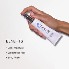 Hand holding ALASTIN Ultra Light Moisturizer for light moisture a weightless feel and a silky finish
