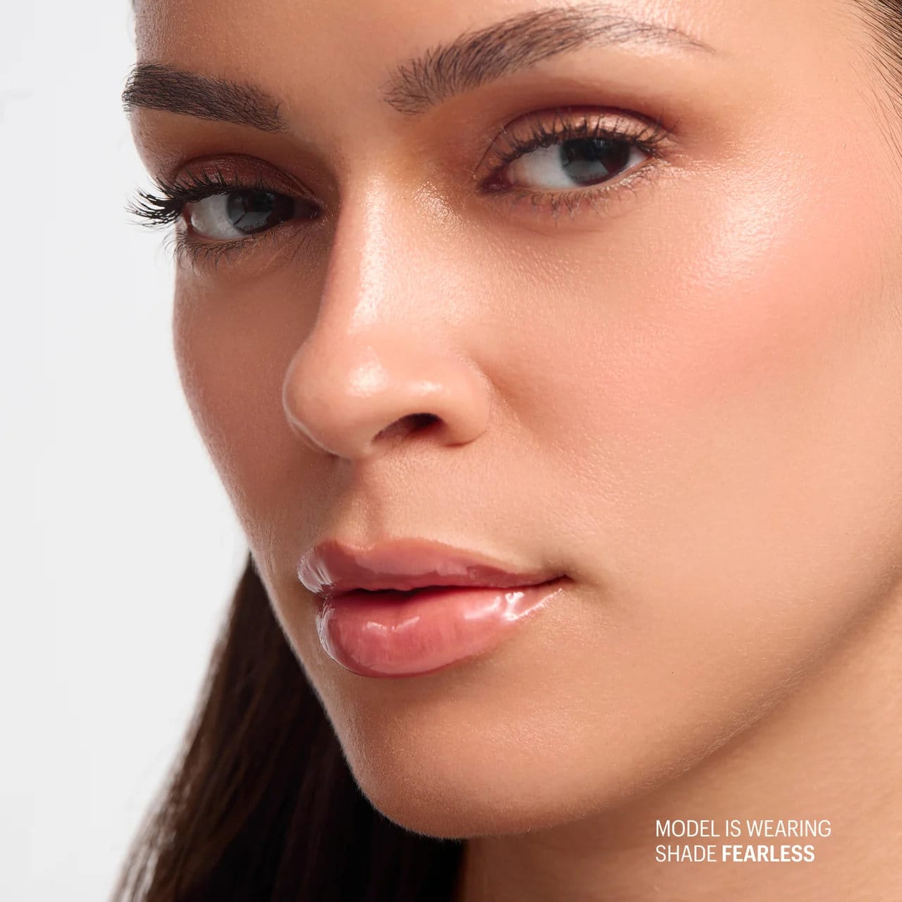 Model wearing Allies of Skin Peptint plumping lip treatment in Fearless for sheer glossy hydrated lips 7
