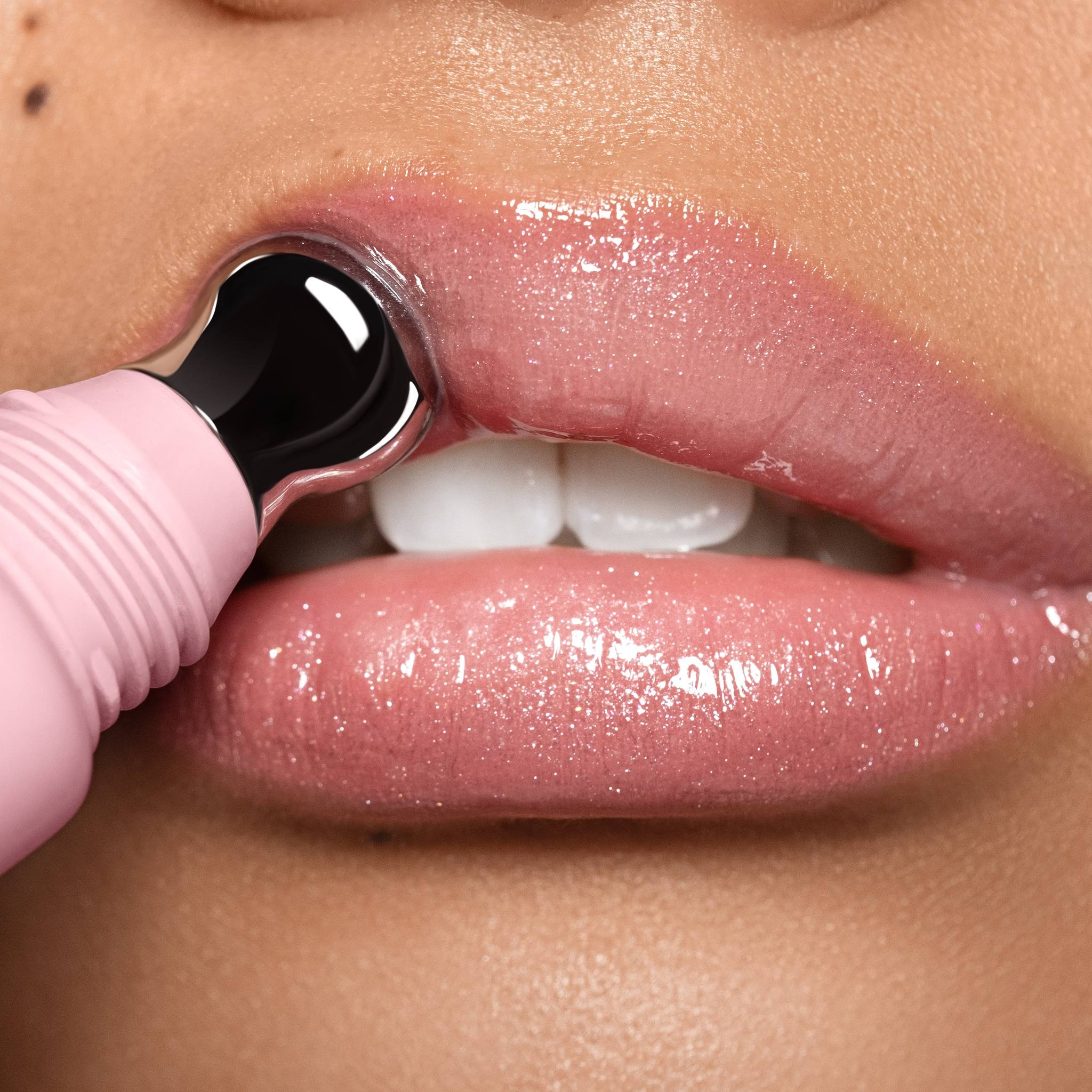 Closeup of glossy shimmer pink lips with Anfisa Skin AN-Gloss Ceramide Lip Tint Angel Food applicator 5