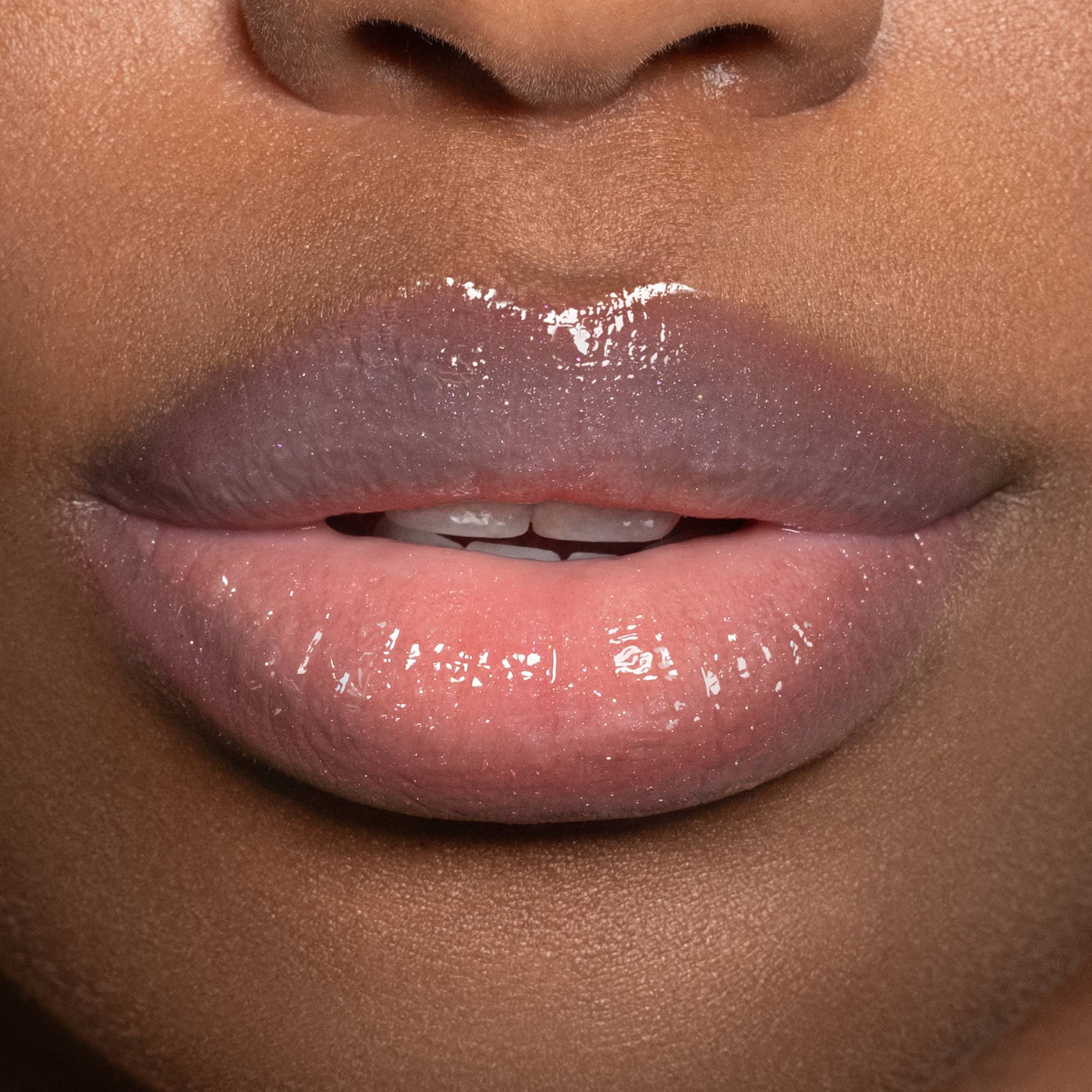 Closeup of glossy shimmer lips on deep skin tone wearing Anfisa Skin AN-Gloss Ceramide Lip Tint Angel Food 7