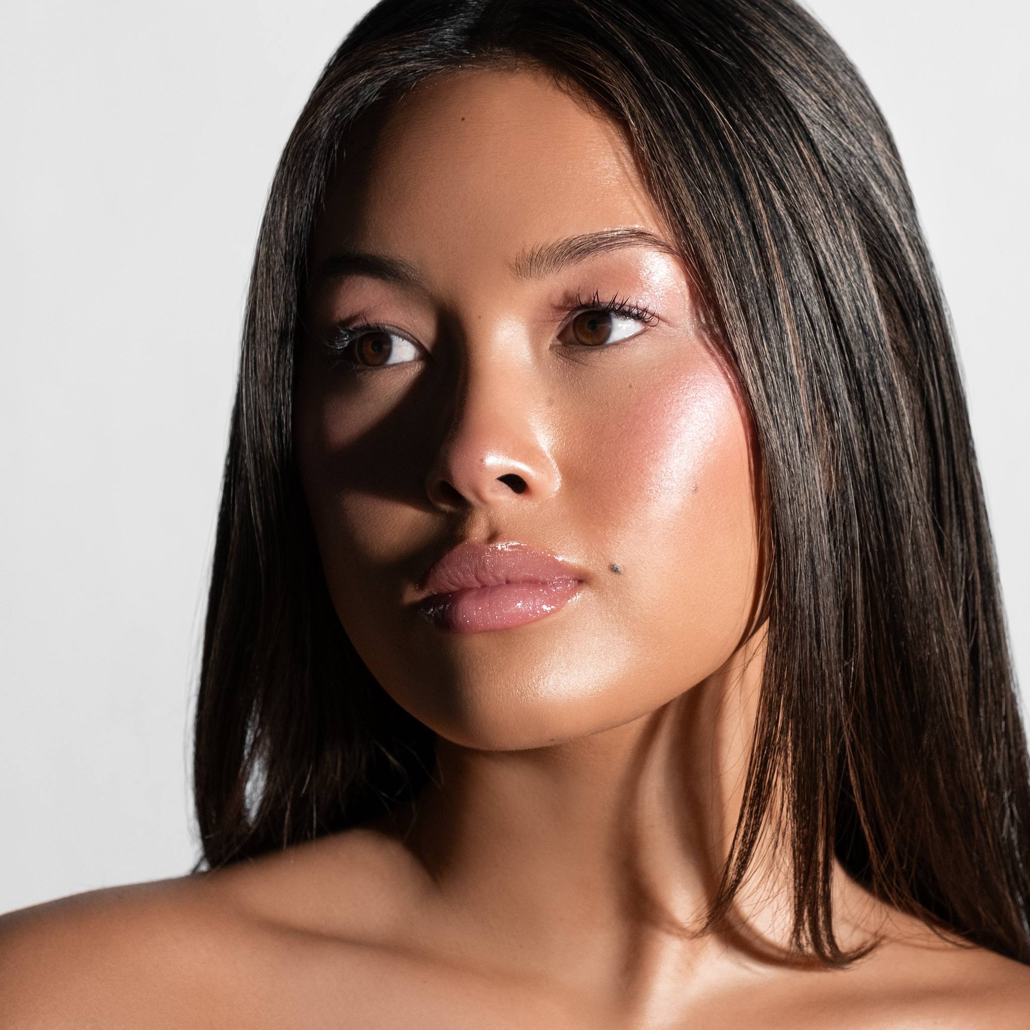 Model with straight dark hair wearing Anfisa Skin AN-Gloss Ceramide Lip Tint Angel Food glossy lips portrait 6