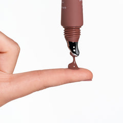 Anfisa Skin AN-Gloss Ceramide Lip Tint Spice Cake warm brown formula dripping from applicator onto finger 6