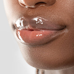 Closeup of glossy lips on deep skin tone wearing Anfisa Skin AN-Gloss Ceramide Lip Treatment Original 7