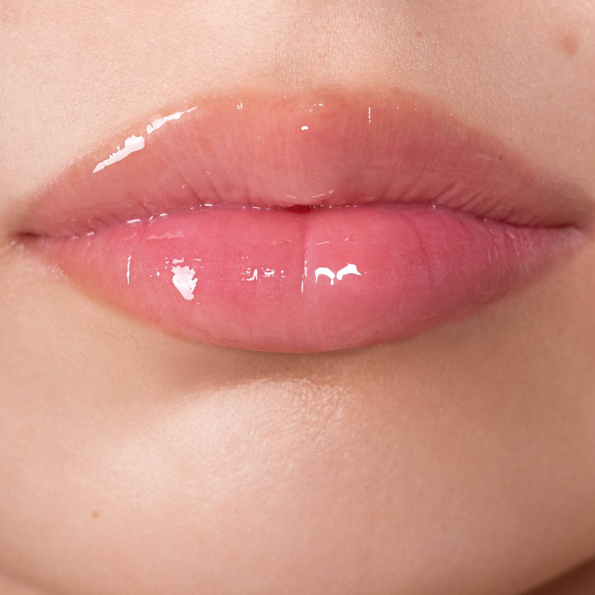 Closeup of glossy plump pink lips wearing Anfisa Skin AN-Gloss Ceramide Lip Treatment 6