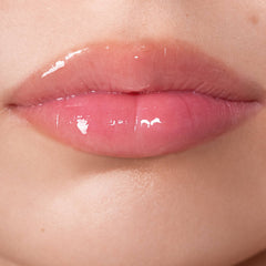 Closeup of glossy plump pink lips wearing Anfisa Skin AN-Gloss Ceramide Lip Treatment 6