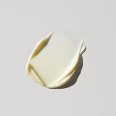 White cream smear on a light gray background