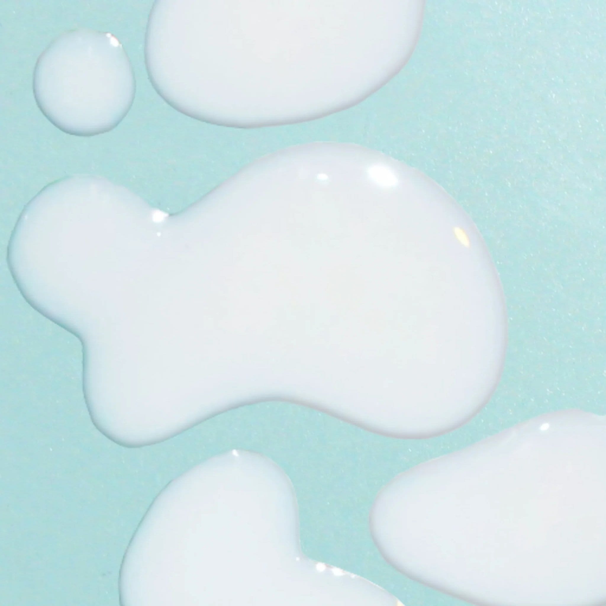 Bask mineral sunscreen serum SPF 30 lightweight serum texture drops and swatches on teal background