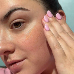 Bask SPF 40 daily invisible gel sunscreen being applied to face showing lightweight glowing finish on skin