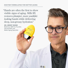 Dr Brent Ridge holding Milk RX hand cream formulated for plumper youthful looking hands