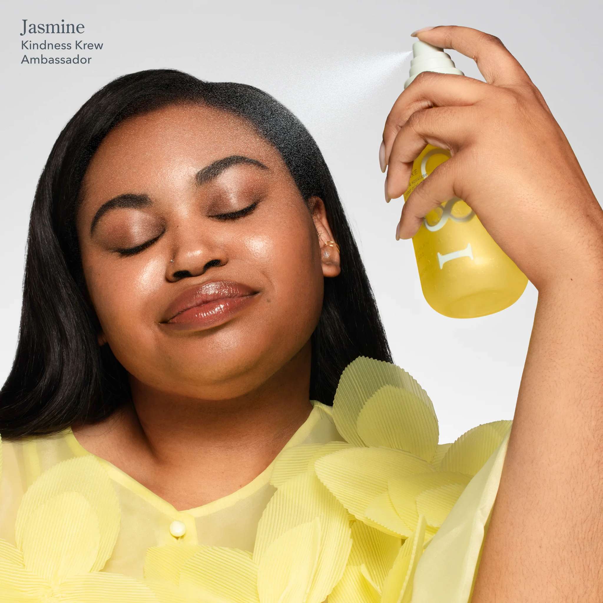 Kindness Krew ambassador Jasmine spraying Milk Shake toner mist onto her face
