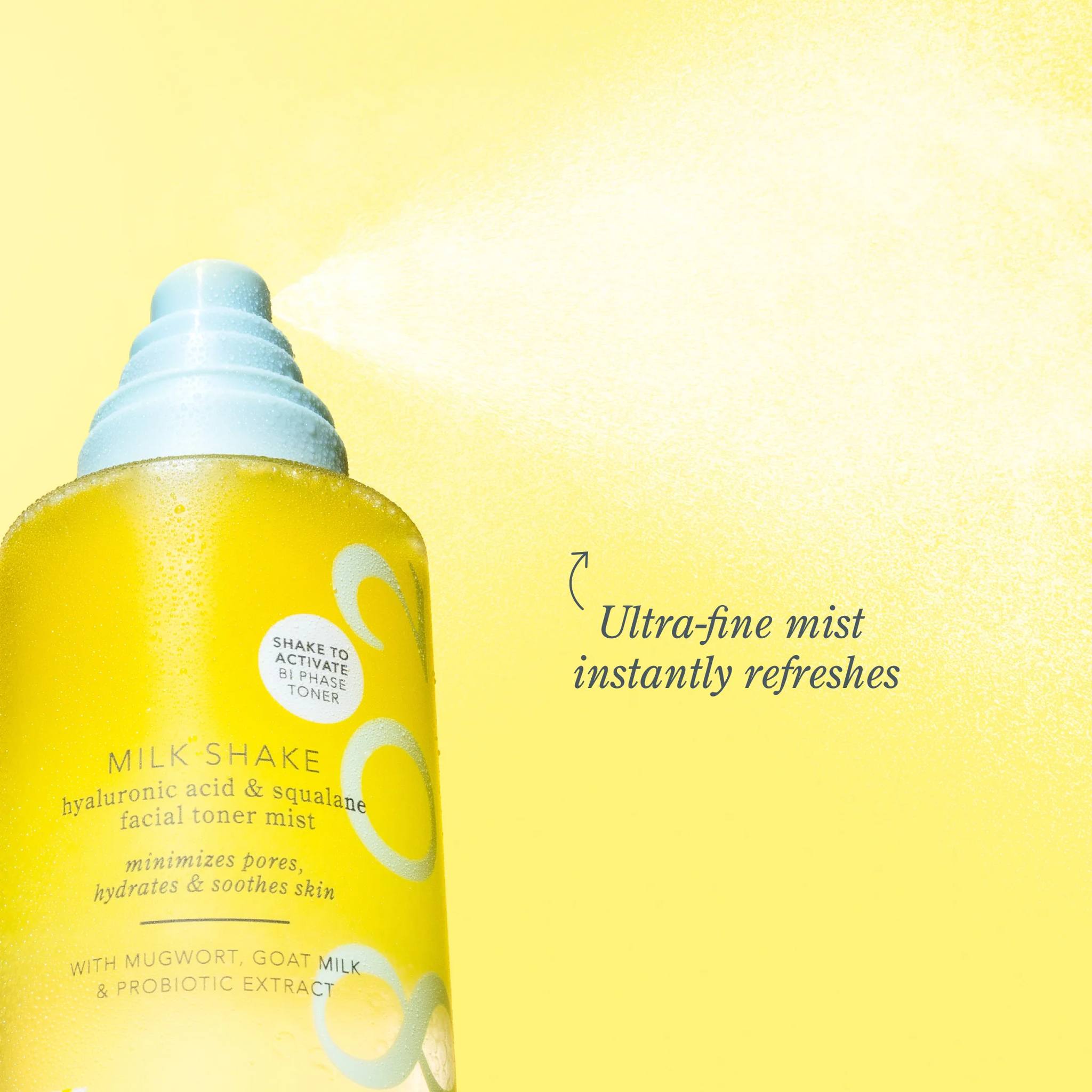 Milk Shake bottle spraying an ultra fine mist against a yellow background