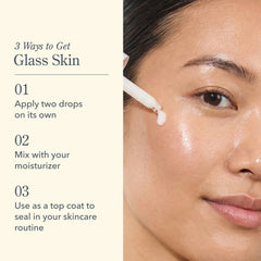 Woman applying Oh Mega Milky Oil dropper directly to cheek for glass skin