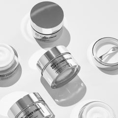 BIOEFFECT EGF Power Cream silver jars arranged in black and white flatlay showing advanced age-defying cream packaging