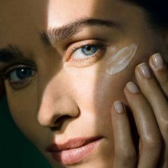 Model applying BioEffect EGF Power Eye Cream under eye area showing cream texture on skin