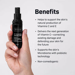 Hand holding a black skincare bottle with text about its benefits on a light gray background