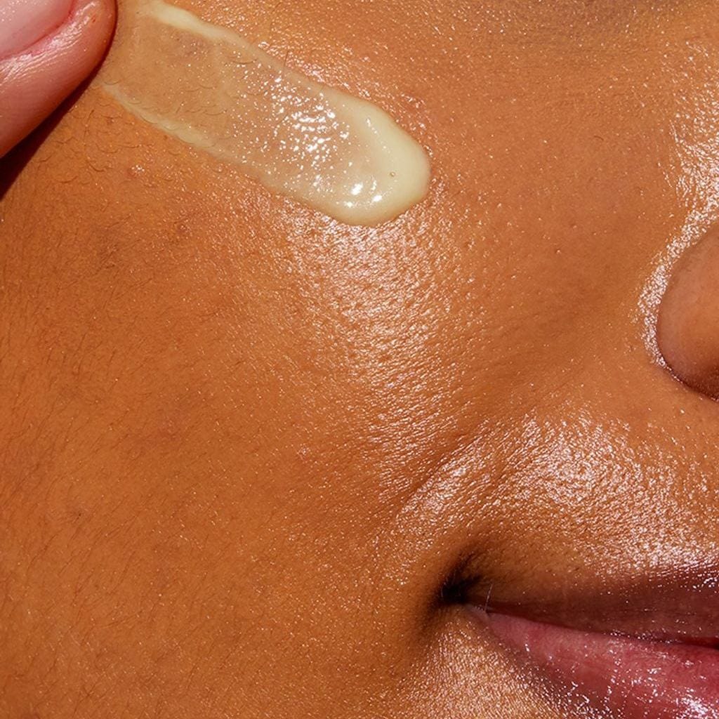 Close-up of CeraVe retinol serum texture swatched on cheek showing a lightweight smoothing face serum