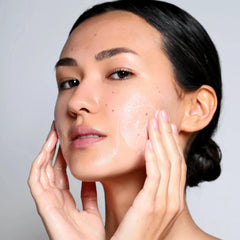 Woman massaging Cosmedix Benefit Clean gentle cleanser into her skin