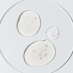 Close-up of Cosmedix Cell ID nutritive defense serum's shimmering gel texture