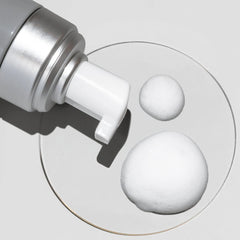 Cosmedix Clarify foaming cleanser foam swatch shown beside its pump