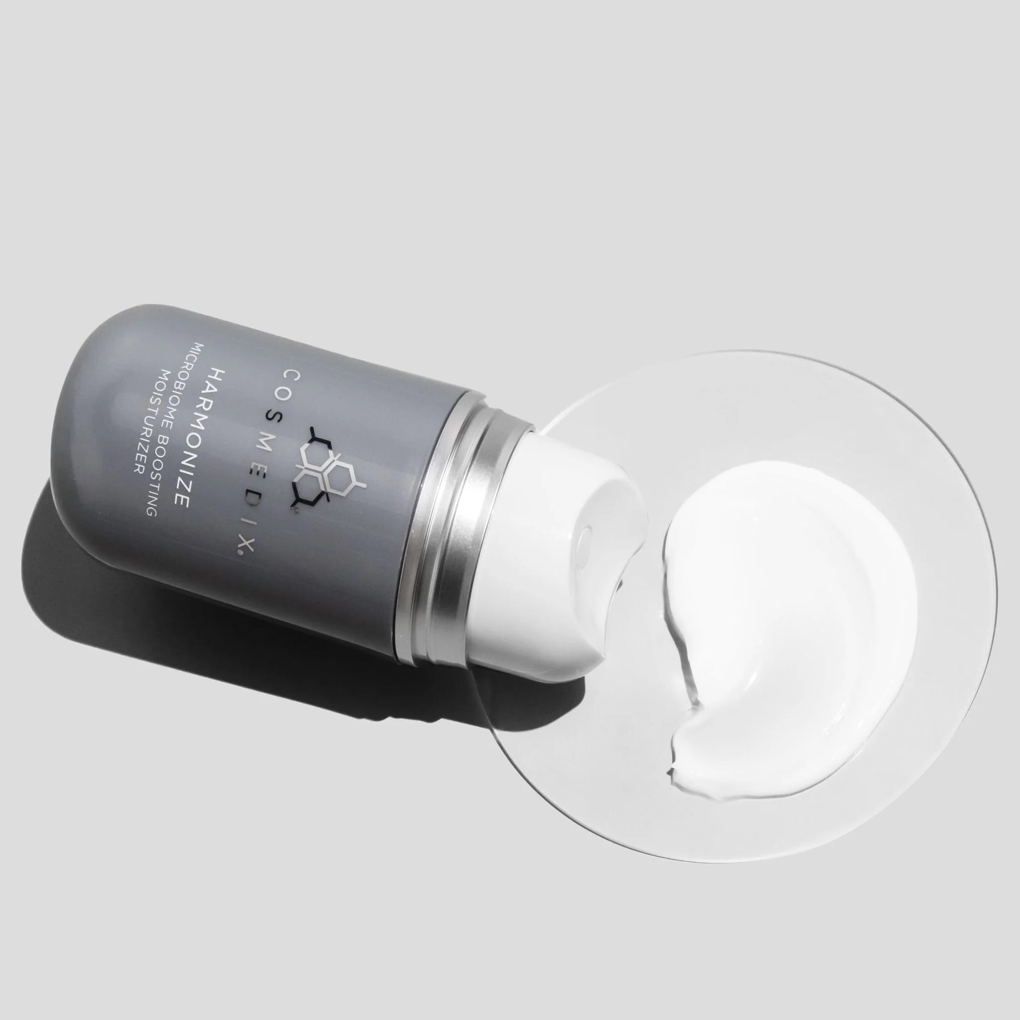 Cosmedix Harmonize moisturizer cream texture shown beside its bottle
