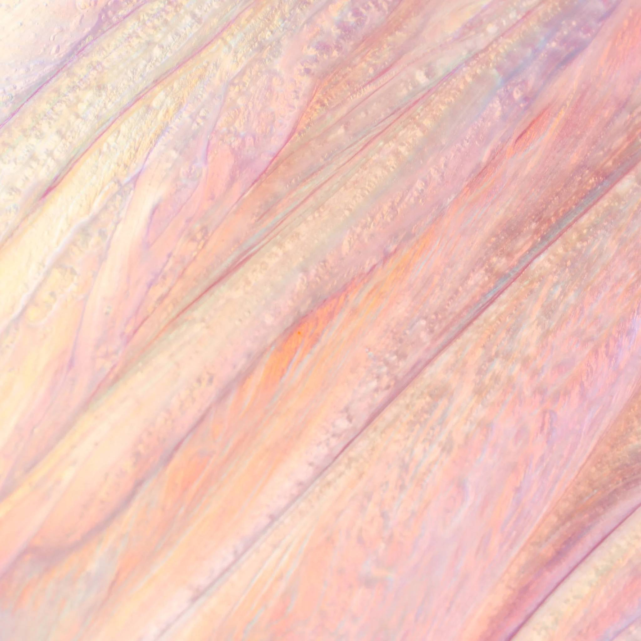 Close-up of Cosmedix Lumi Crystal lip hydrator's iridescent shimmer texture