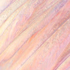 Close-up of Cosmedix Lumi Crystal lip hydrator's iridescent shimmer texture