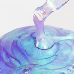 Cosmedix Opti Crystal eye serum's iridescent gel dripping in swirl