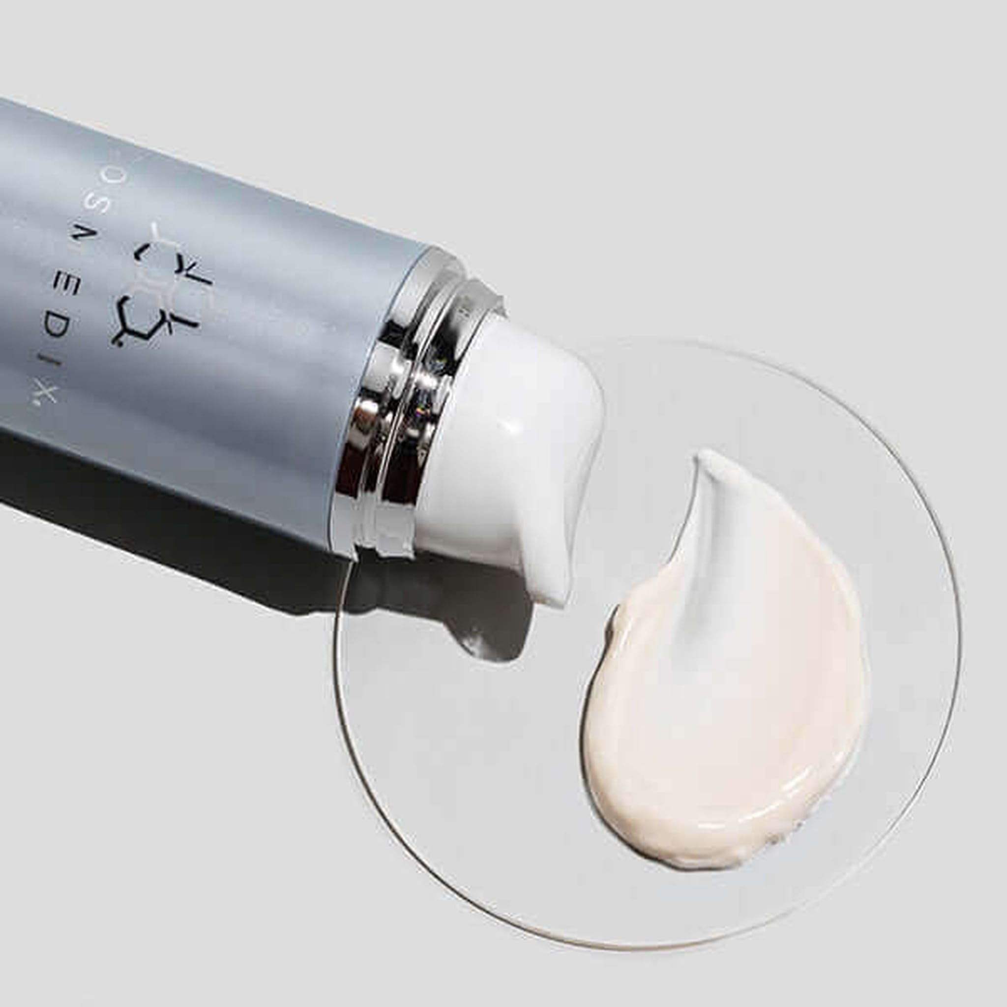 Cosmedix Peptide-Rich Defense SPF 50 moisturizer texture swatch beside bottle
