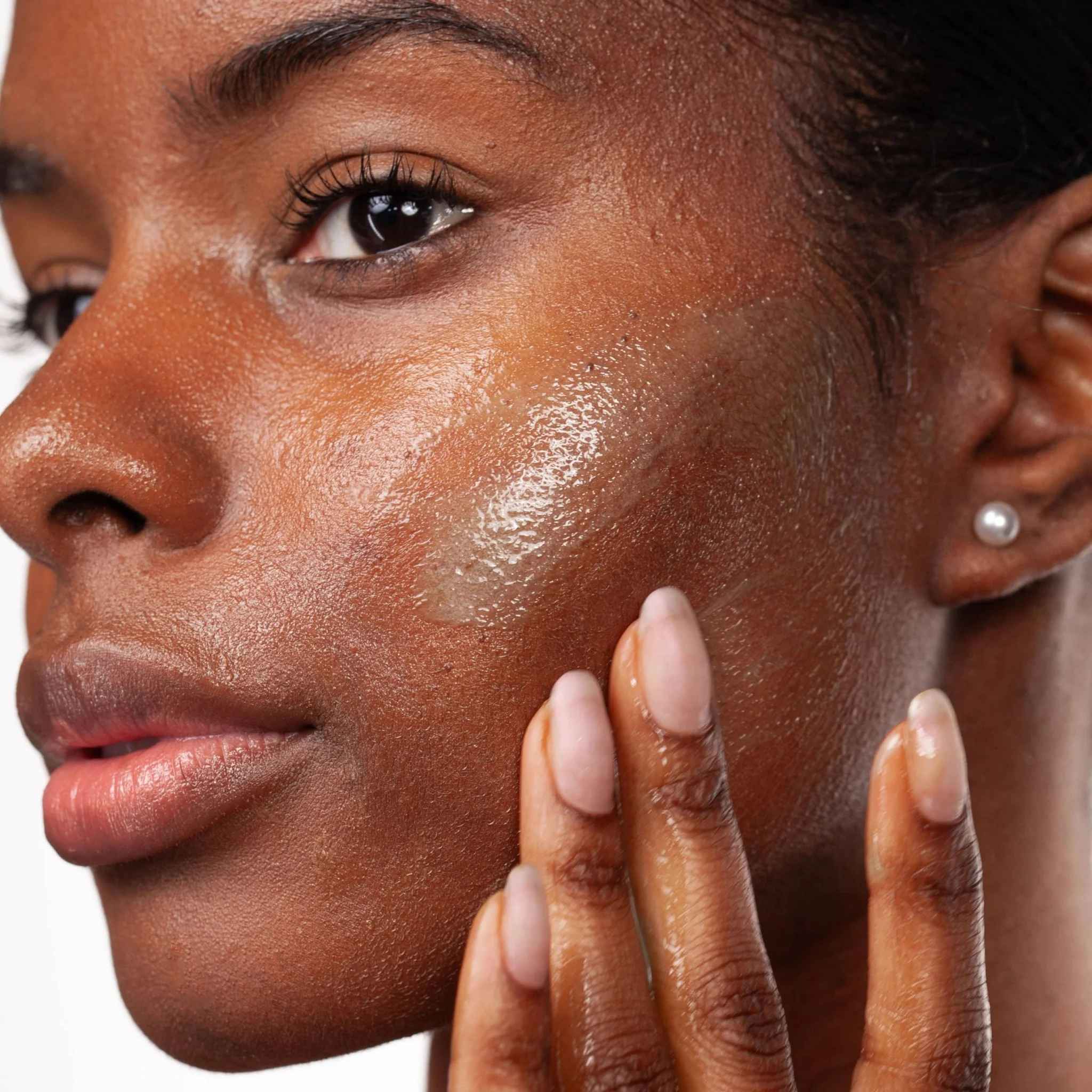 Woman massaging Cosmedix Purity Clean exfoliating cleanser into her skin