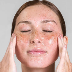Woman massaging Cosmedix Purity Solution deep cleansing oil into her skin