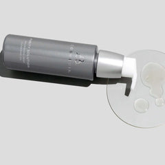 Cosmedix Purity Solution deep cleansing oil texture droplets beside bottle