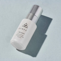 Cosmedix Revert boosting brightening serum bottle on blue background