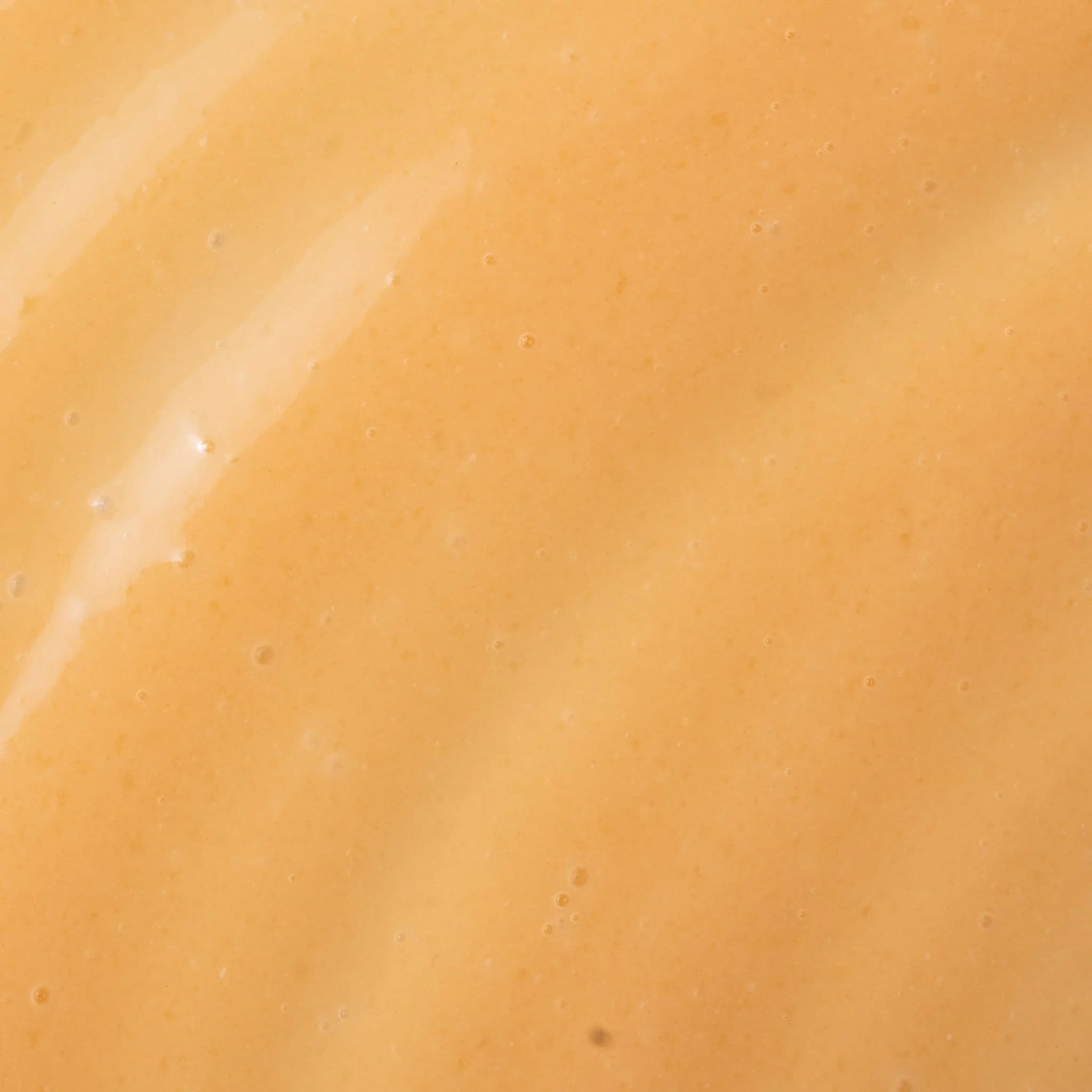 Close-up of Cosmedix Revert boosting brightening serum's golden gel texture