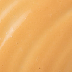 Close-up of Cosmedix Revert boosting brightening serum's golden gel texture
