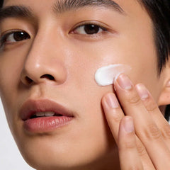 Person applying Cyspera Ageless Skin Resilience Face Cream to cheek for anti-aging redness reduction and even skin tone routine